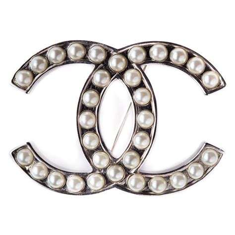 silver chanel logo|Chanel brooch price.